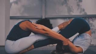 Two people doing yoga together