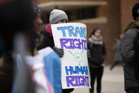 A group of about 60 transgender individuals, nonbinary individuals and cisgender allies listen to speakers at the University of Minnesota campus in Minneapolis.