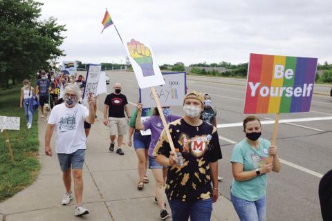 Robbinsdale protestors with pride signs