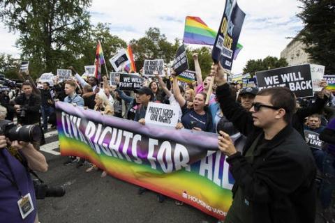 In this Oct. 8, 2019 photo, supporters of LGBT rights stage a protest on the street in front of the U.S. Supreme Court in Washington
