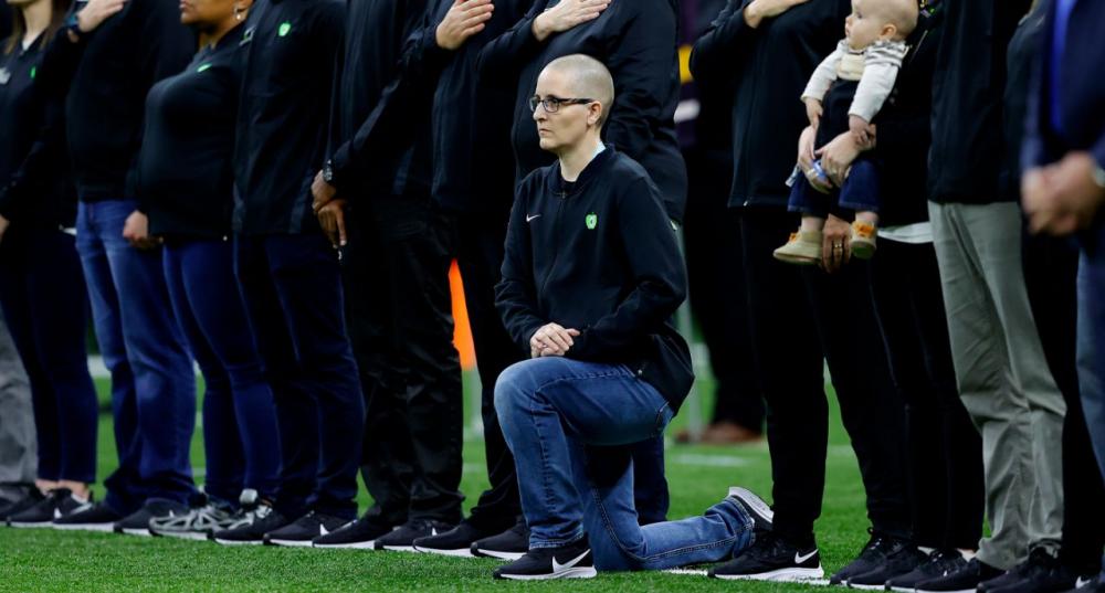 "Teacher of the Year" Kelly Holstine kneeled during the National Anthem at the College Football Playoff National Championship game on January 13, with President and Melania Trump in attendance. (Photo: Getty Images)