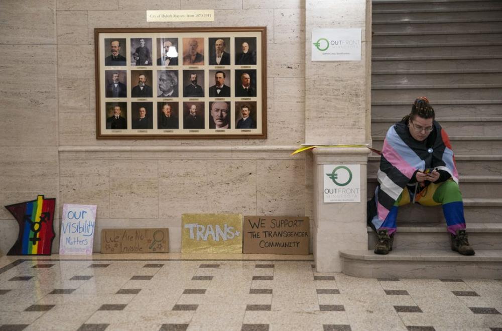 Jason Robinson sat checking his phone before the start of the rally in Duluth City Hall on Monday night.