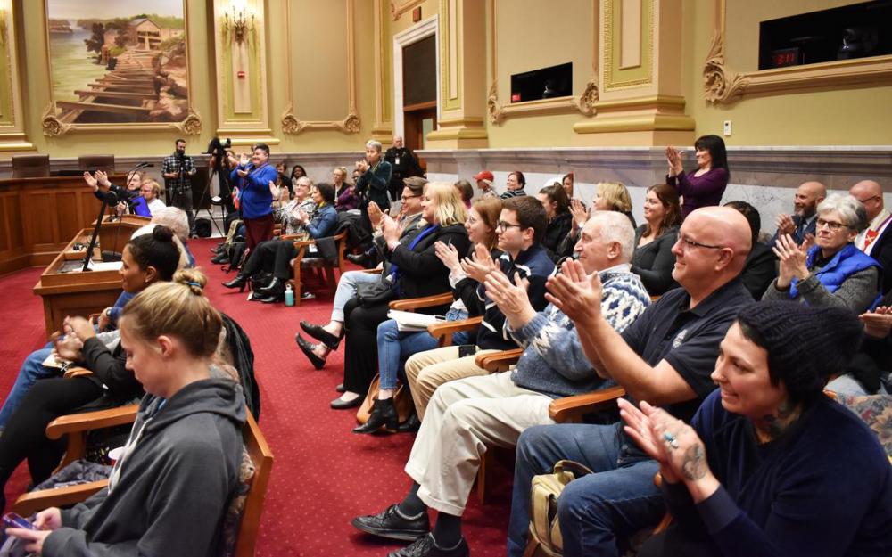 An audience applauds a Minneapolis City Council committee's unanimous vote to move forward a bill banning LGBTQ+ conversion therapy for children under 18 in city limits on Monday, Nov. 18.